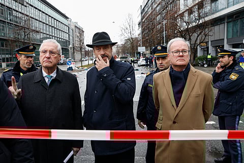 Bavaria's State Premier and Leader of the conservative Christian Social Union (CSU) Markus Soeder (C) arrives with Joachim Herrmann (L), Bavaria's Interior Minister at the scene where a car drove into a crowd in the southern German city of Munich on February 13, 2025 leaving several people injured, police said.