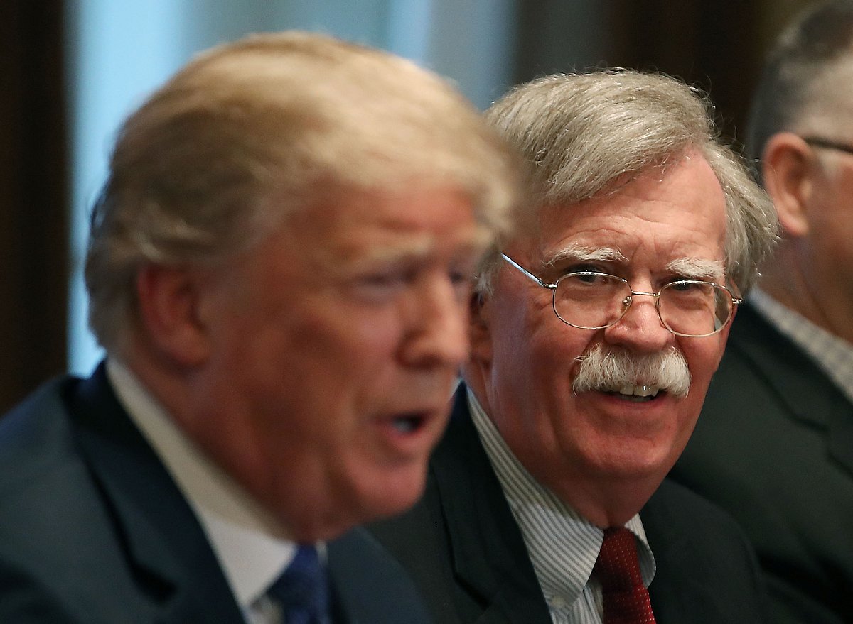 National Security Advisor John Bolton (R), listens to US President Donald Trump as he speaks about the FBI raid at lawyer Michael Cohen's office, while receiving a briefing from senior military leaders regarding Syria, in the Cabinet Room, on April 9, 2018 in Washington, DC. 