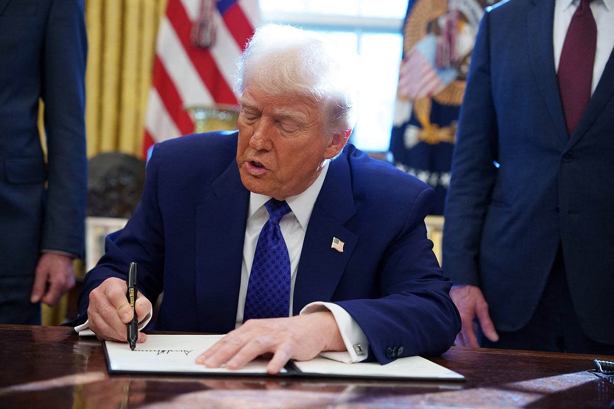 US President Donald Trump signs an executive order establishing the Energy Dominance Council led by Secretary of the Interior Doug Burgum in the Oval Office at the White House on February 14, 2025 in Washington, DC. 