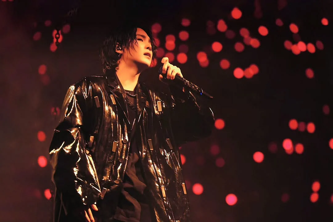 BTS' Suga made a signature look for himself during the D-Day tour, which included ripped jeans, tailored jackets and long hair. 