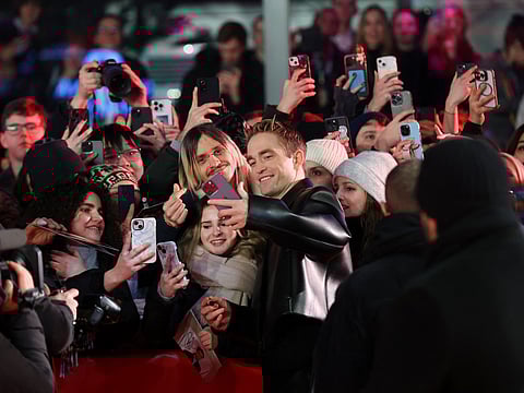 English actor Robert Pattinson (C-R) poses for selfies with fans as he arrives on the red carpet of the film 'Mickey 17' presented as Berlinale Special Gala at the 75th Berlinale, Europe's first major film festival of the year, in Berlin on February 15, 2025.