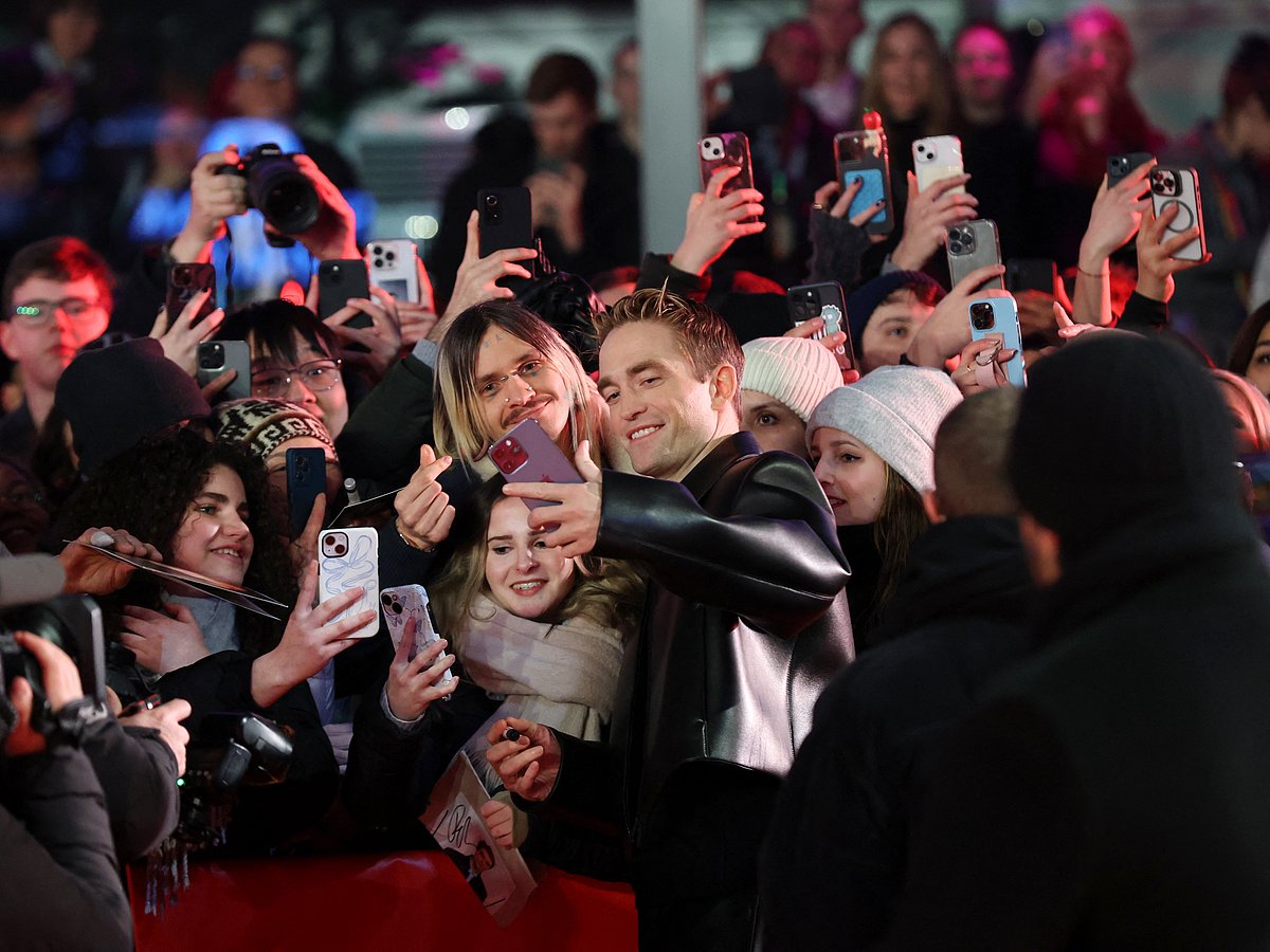 English actor Robert Pattinson (C-R) poses for selfies with fans as he arrives on the red carpet of the film 'Mickey 17' presented as Berlinale Special Gala at the 75th Berlinale, Europe's first major film festival of the year, in Berlin on February 15, 2025.