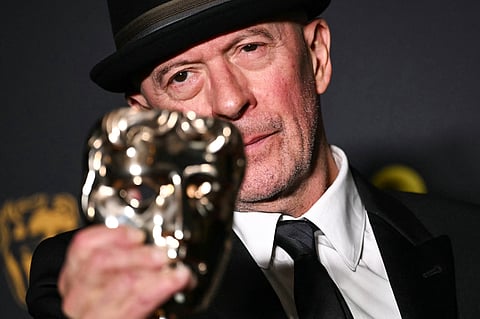 French movie director Jacques Audiard poses with the award for Best film not in English language for "Emilia Perez" during the BAFTA British Academy Film Awards ceremony at the Royal Festival Hall, Southbank Centre, in London, on February 16, 2025.