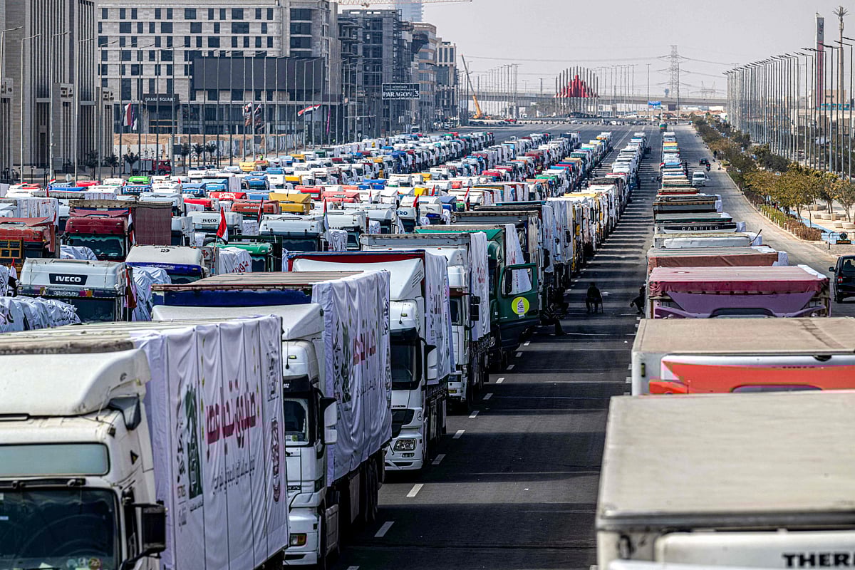A convoy of trucks loaded with humanitarian aid supplies for the Gaza Strip waits at Egypt's New Administrative Capital, about 45 kilometres east of Cairo, on February 16, 2025.  