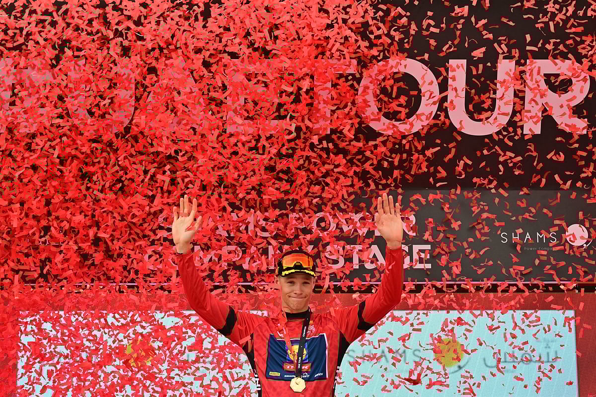 Lidl-Trek team's Italian rider Jonathan Milan celebrates on the podium after winning the first stage of the UAE Tour cycling race from Shams Solar Power Station Madinat Zayed to Liwa Palace in Abu Dhabi on February 17.