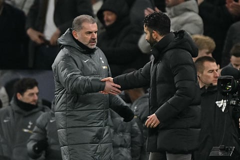 Tottenham Hotspur's Greek-Australian Head Coach Ange Postecoglou (left) greets Manchester United's Portuguese head coach Ruben Amorim after the English Premier League football match at the Tottenham Hotspur Stadium in London, on February 16.