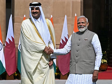 Qatar's Emir Sheikh Tamim bin Hamad Al-Thani (L) shakes hands with India's Prime Minister Narendra Modi before their meeting at the Hyderabad House in New Delhi on February 18, 2025.
