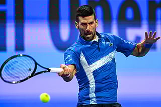 Serbia's Novak Djokovic hits a return to Italy's Matteo Berettini during their men's singles match at the ATP Qatar Open tennis tournament in Doha on February 18, 2025.