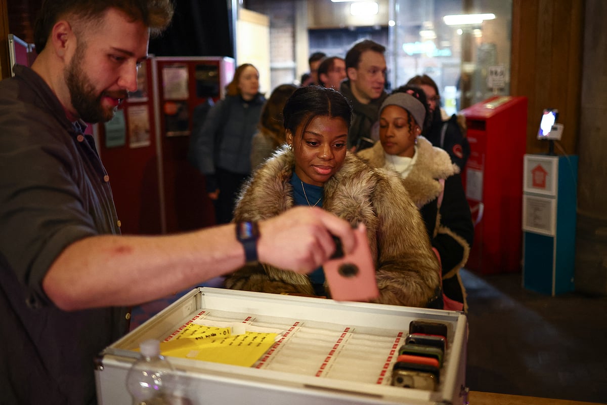People hand in their mobile phones while attending an event run by The Offline Club, at the Sherriff Centre in London on February 12, 2025.