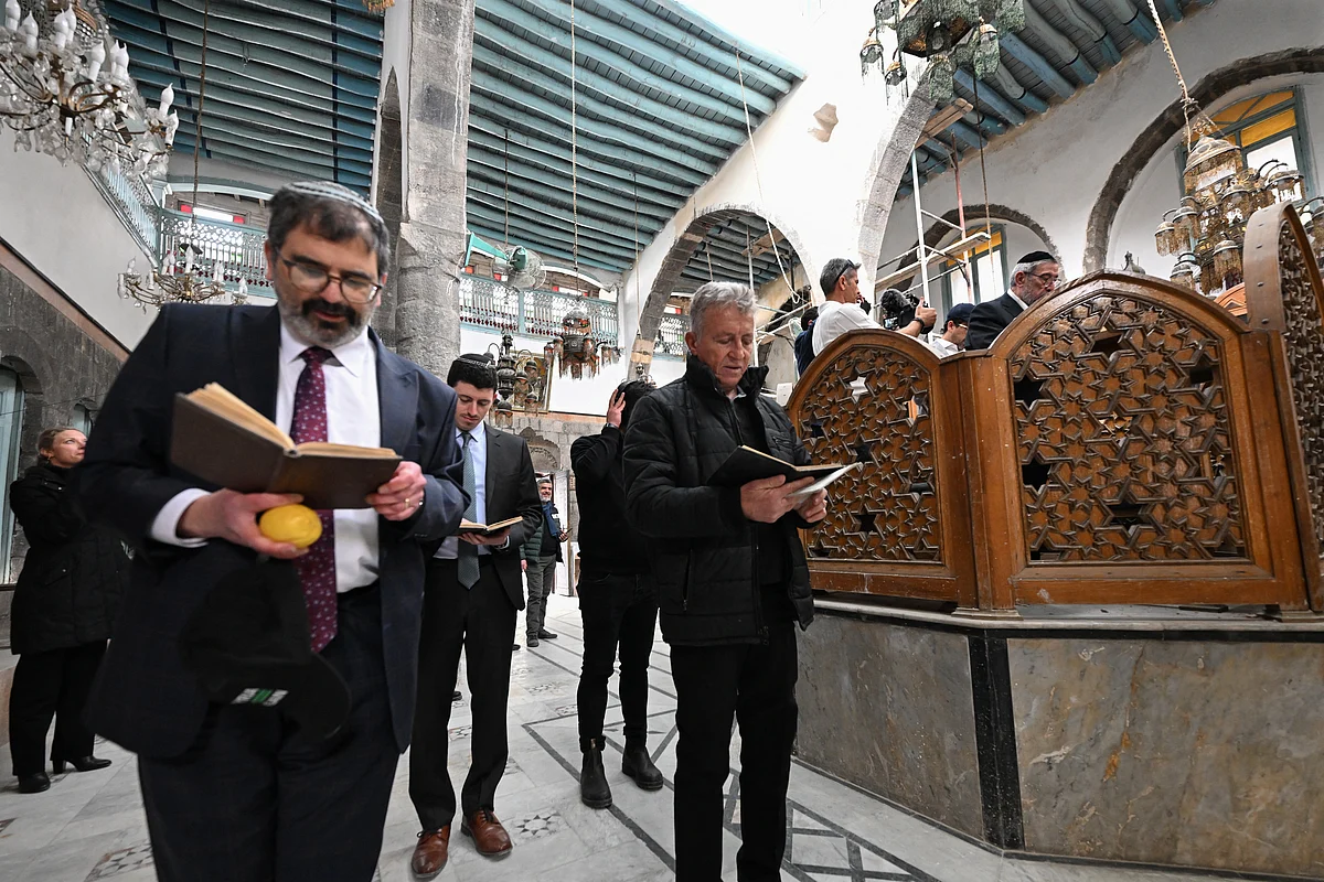 Visiting Jewish worshippers attend the first prayer since 1992, held in the Ifrange Synagogue in the Jewish quarter in Old Damascus' Bab Sharqi neighbourhood, on February 19, 2025.
