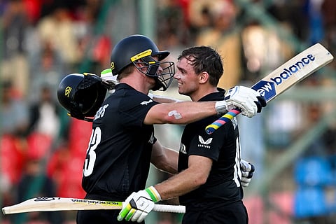 New Zealand's Tom Latham (right) celebrates with Glenn Phillips after scoring a century during the ICC Champions Trophy cricket against Pakistan at the National Stadium in Karachi on February 19.