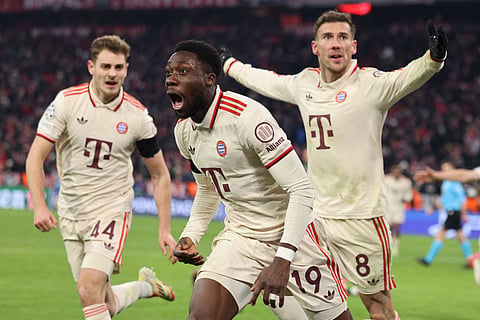 Bayern Munich's Canadian defender Alphonso Davies celebrates with Croatian defender Josip Stanisic and German midfielder Leon Goretzka after scoring the equalising goal during the Uefa Champions League second-leg, knockout phase play-off match against Celtic on February 18.