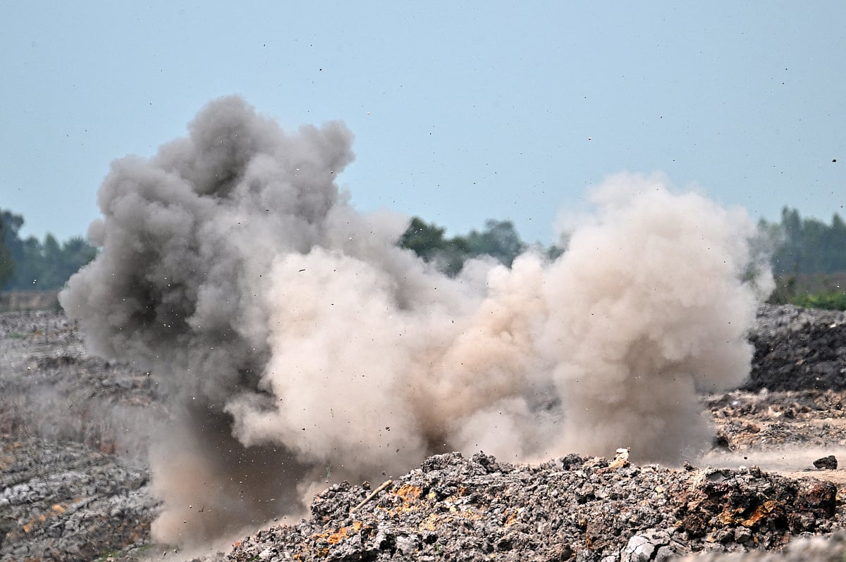 Smoke and dust rising after deminers from the Cambodian Mine Action Centre (CMAC) destroyed an unexploded ordnance (UXO) unearthed during irrigation work in Svay Rieng province.