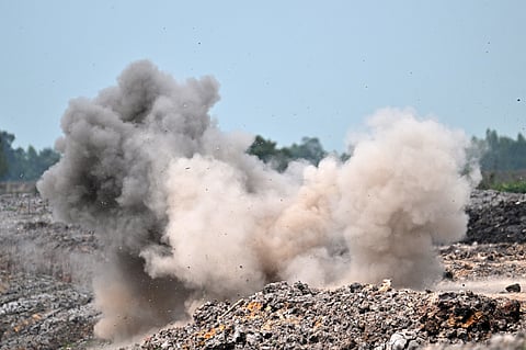 Smoke and dust rising after deminers from the Cambodian Mine Action Centre (CMAC) destroyed an unexploded ordnance (UXO) unearthed during irrigation work in Svay Rieng province.