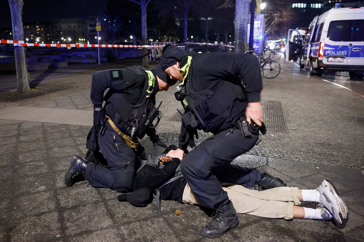 Police apprehend a suspect at the scene where a person was stabbed near the memorial of the murdered jews of Europe in Berlin on February 21, 2025.