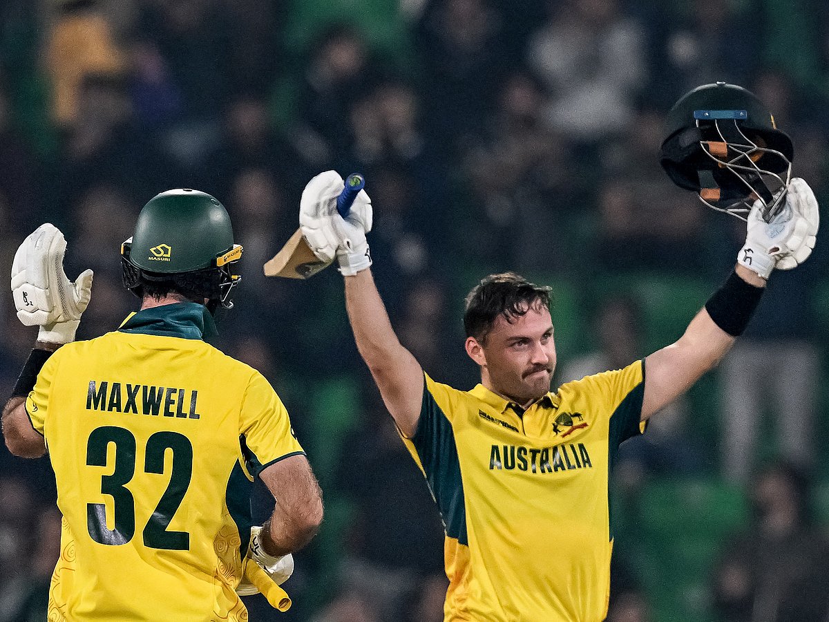Australia's Josh Inglis (R) celebrates after scoring a century during the ICC Champions Trophy ODI)cricket match against England at the Gaddafi Stadium in Lahore on February 22, 2025.