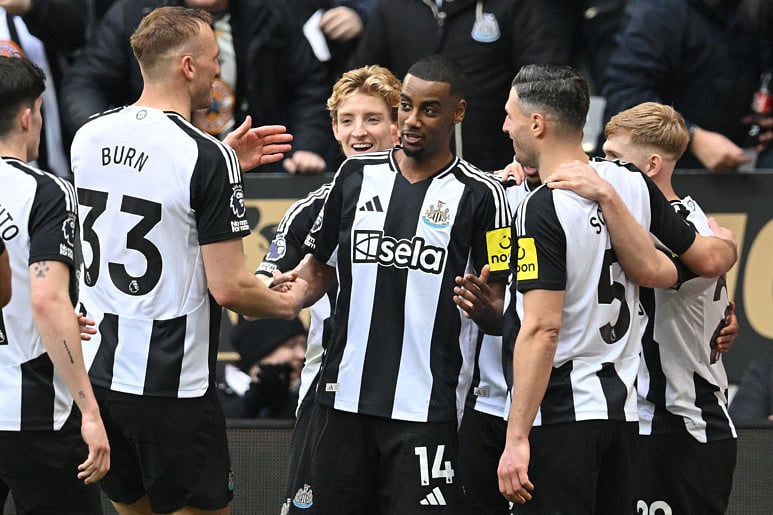 Newcastle United's Swedish striker Alexander Isak (centre) celebrates with teammates after scoring their third goal from the penalty spot during the English Premier League football match against Nottingham Forest at St James' Park in Newcastle-upon-Tyne, north east England on February 23.