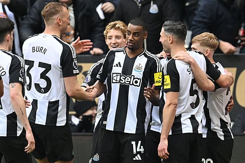 Newcastle United's Swedish striker Alexander Isak (centre) celebrates with teammates after scoring their third goal from the penalty spot during the English Premier League football match against Nottingham Forest at St James' Park in Newcastle-upon-Tyne, north east England on February 23.