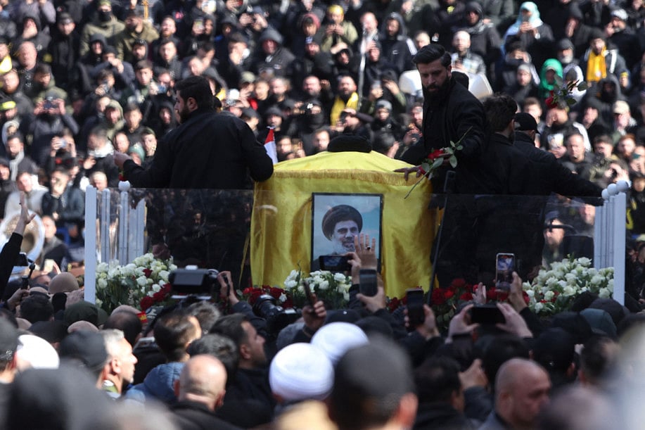 The coffins of Hezbollah's slain leaders Hassan Nasrallah and Hashem Safieddine are paraded during their funeral ceremony at the Camille Chamoun Sports City Stadium on the outskirts of Beirut on February 23, 2025.  