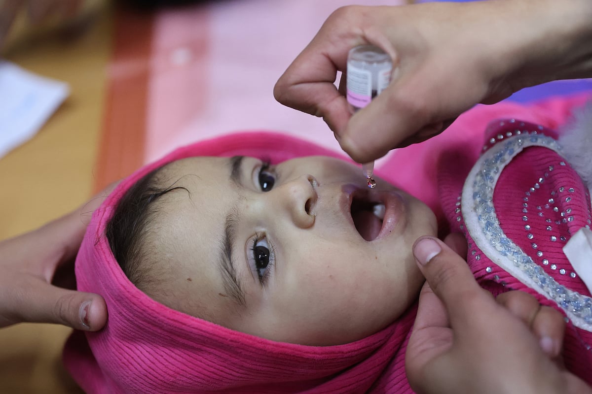 A Palestinian child receives a polio vaccine on the first day of classes at a school in Gaza City on February 23, 2025, as part of a polio vaccination campaign.