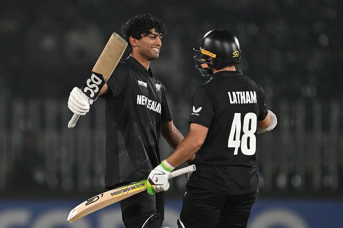 New Zealand’s Rachin Ravindra (left) celebrates after scoring a century with teammate Tom Latham during the ICC Champions Trophy One-Day International (ODI) cricket match against Bangladesh at the Rawalpindi Cricket Stadium in Rawalpindi on February 24.