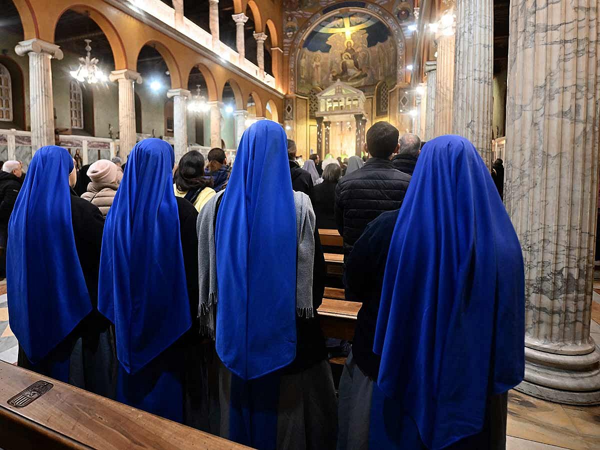 Nuns attend an eucharistic celebration for the health of Pope Francis at the Argentinian church of Santa Maria Addolorata, in Rome on February 25, 2025.