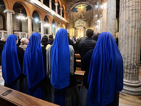 Nuns attend an eucharistic celebration for the health of Pope Francis at the Argentinian church of Santa Maria Addolorata, in Rome on February 25, 2025. 