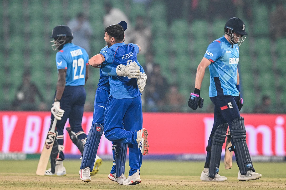 Afghanistan's bowler Azmatullah Omarzai (centre) celebrates with Afghanistan's wicketkeeper Rahmanullah Gurbaz after taking the wicket of England's Jamie Overton during the ICC Champions Trophy One-Day International (ODI) cricket match at the Gaddafi Stadium in Lahore on February 26.