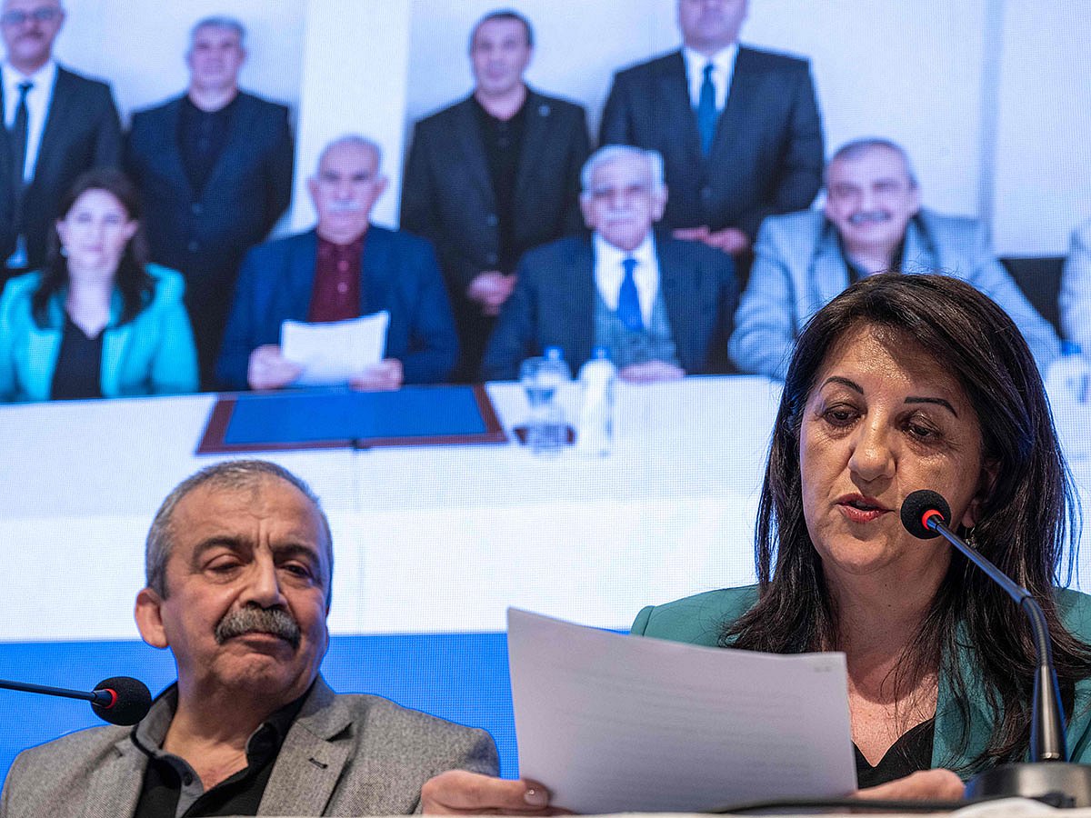 Pervin Buldan (right), MP of Equality and Democracy (DEM) Party, reads a statement from jailed Kurdish leader Abdullah Ocalans (left) call during the press conference hold by DEM Party officials in Istanbul, on February 27, 2025.
