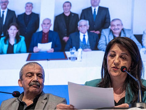 Pervin Buldan (right), MP of Equality and Democracy (DEM) Party, reads a statement from jailed Kurdish leader Abdullah Ocalans (left) call during the press conference hold by DEM Party officials in Istanbul, on February 27, 2025.  