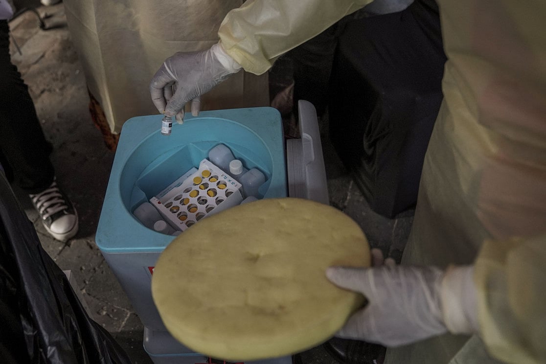 A clinician holds a vial of the mpox vaccine during the launch of a vaccination campaign at The General Hospital of Goma. 