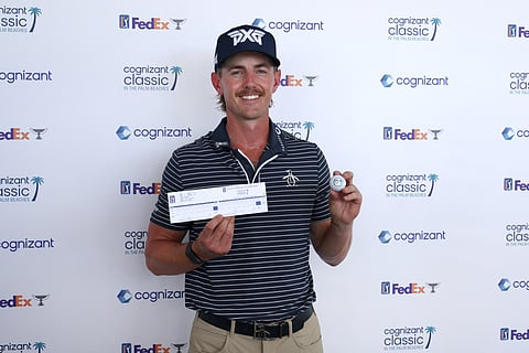 Jake Knapp poses with his scorecard and his ball after shooting a 59 during the first round of the Cognizant Classic