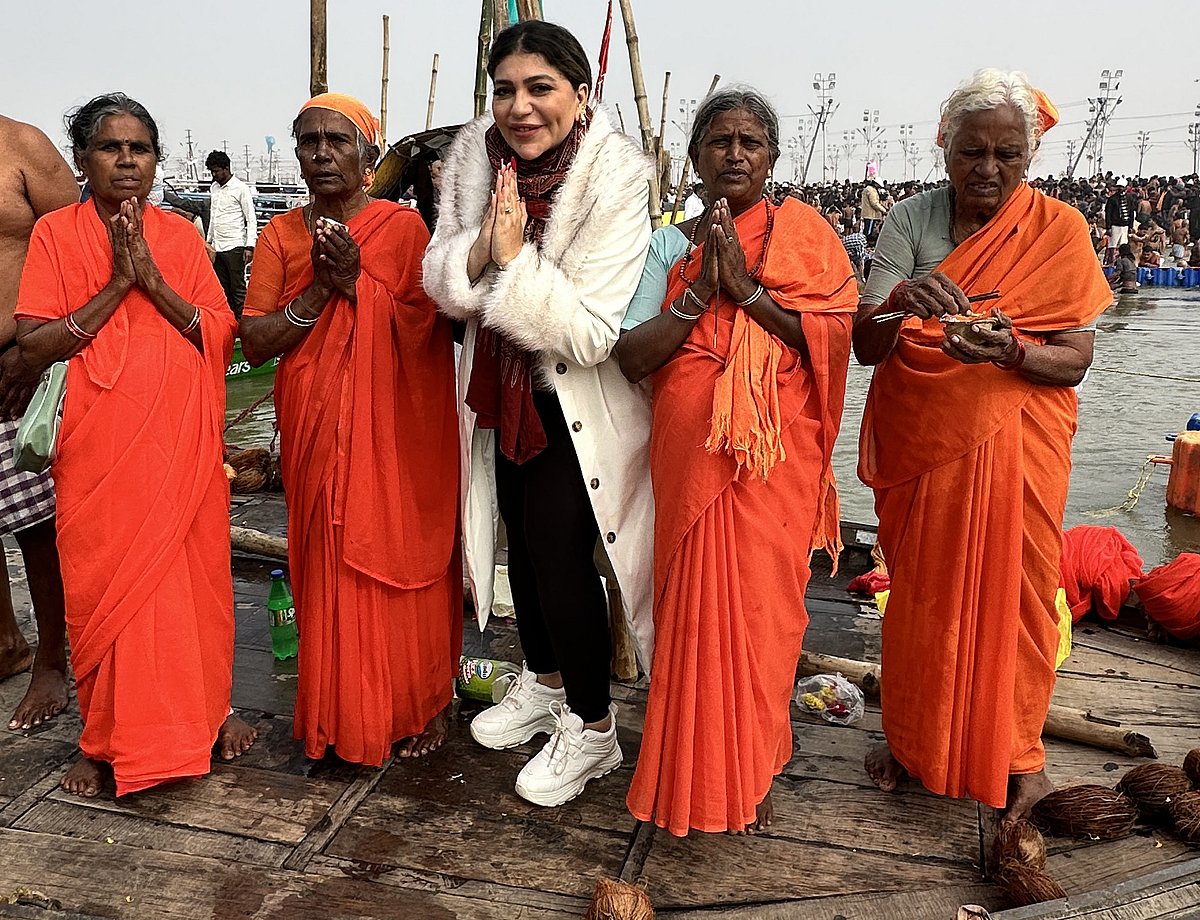 Sally El Azab, Arab expat in Abu Dhabi, poses for a picture with pilgrims at Maha Kumbh Mela in India 