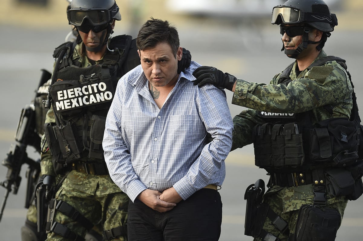 The alleged leader of the Zetas drug carteL, Oscar Omar Trevino, aka "Z-42" is taken under custody to be presented to the press at the Attorney General Office's hangar at the airport in Mexico City, on March 4, 2015.