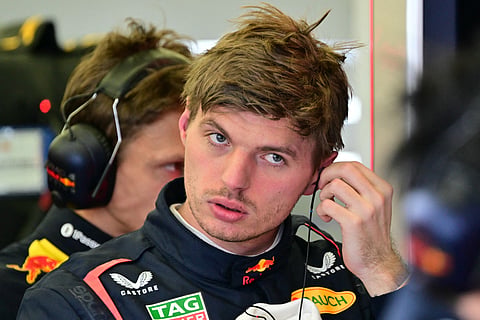 Red Bull Racing's Dutch driver Max Verstappen removes his earpiece after a lap on the third day of the Formula One pre-season testing at the Bahrain International Circuit in Sakhir on February 28, 2025.