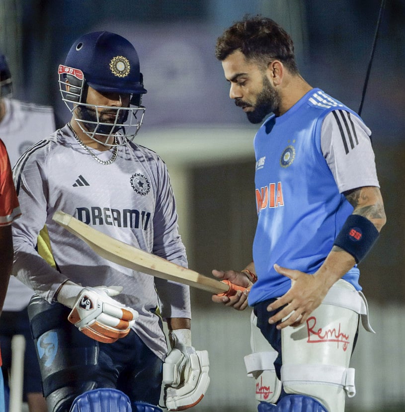 Virat Kohli inspecting the bat of Rishabh Pant during a practice session at the ICC Academy Grounds in Dubai.