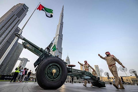 Emirati officers prepare to fire the Iftar cannon near Burj Khalifa in the centre of Dubai, a tradition signalling sunset and the end of fasting for observing Muslims.