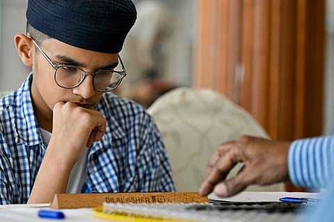 Pakistani prodigy Bilal Asher, world under-14 Scrabble champion, competes against professional Scrabble coach Waseem Khatri during an event organised by the Pakistan Scrabble Association (PSA) at the Beach Luxury hotel in Karachi.  