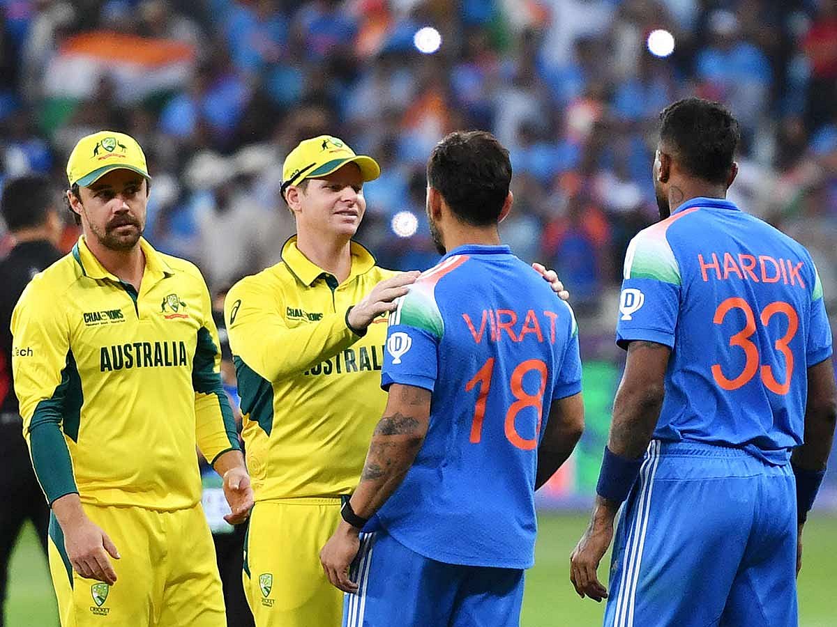 Australia's captain Steve Smith (2L) greets India's Virat Kohli as India's Hardik Pandya (R) watches at the end of the ICC Champions Trophy one-day international (ODI) semi-final cricket match at the Dubai International Stadium in Dubai on March 4, 2025. 
