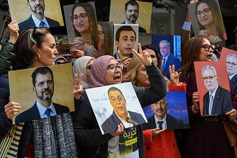 Relatives of detainees accused of involvement in a conspiracy case against state security, gesture on the day of a first hearing in front of the court in Tunis on March 4, 2025.  