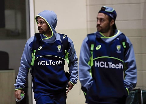 Australia's Travis Head (left) arrives for a training session in Dubai on Monday. The opener has been a big headache for India in recent times.