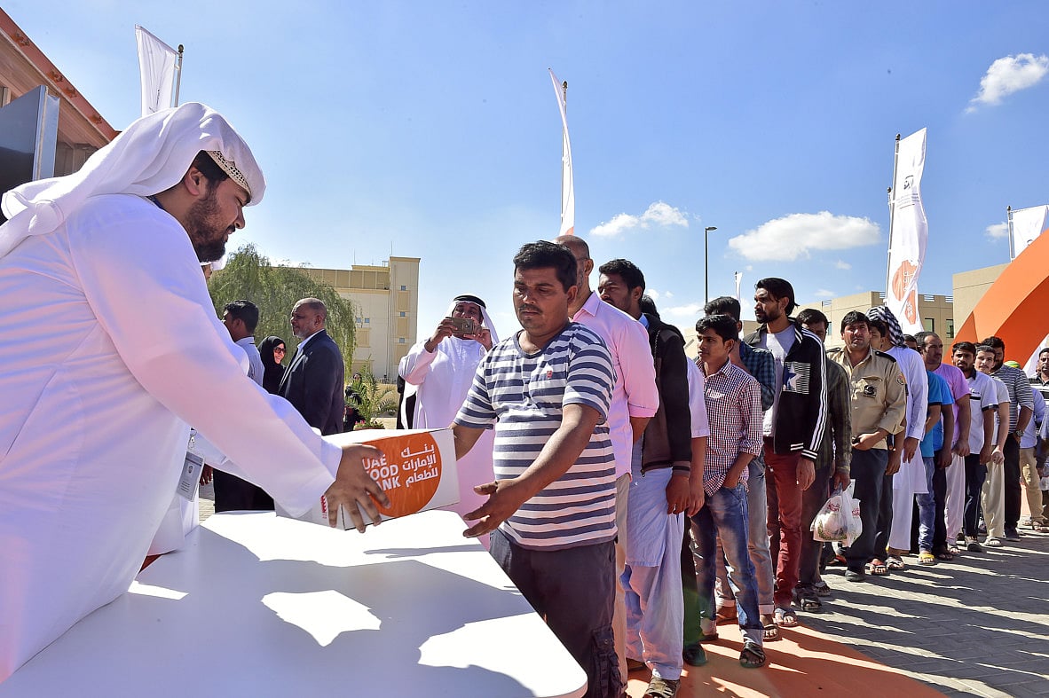 UAE Food Bank staff distribute food bags to workers.  File photo