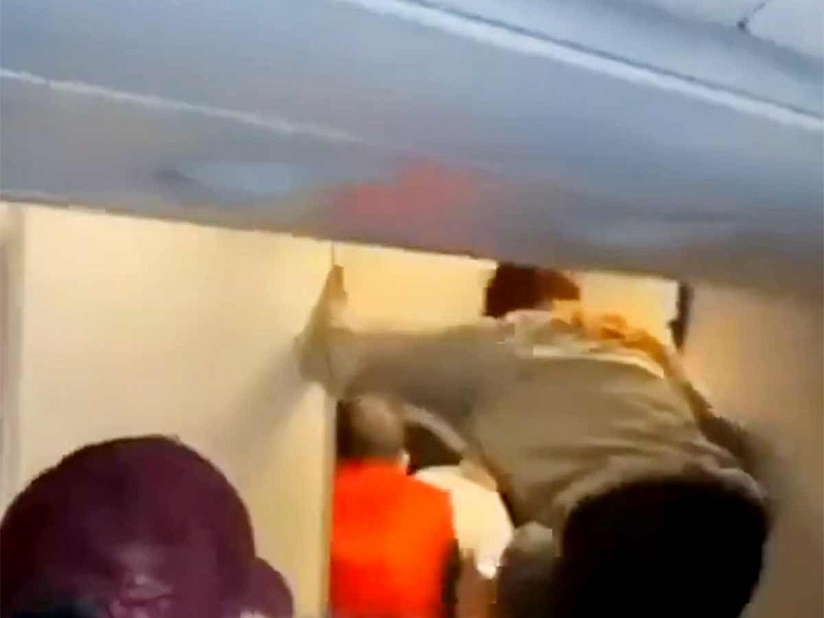 Video footage from the flight captured the tense moments, showing crew members wrestling the passenger away from the door. 