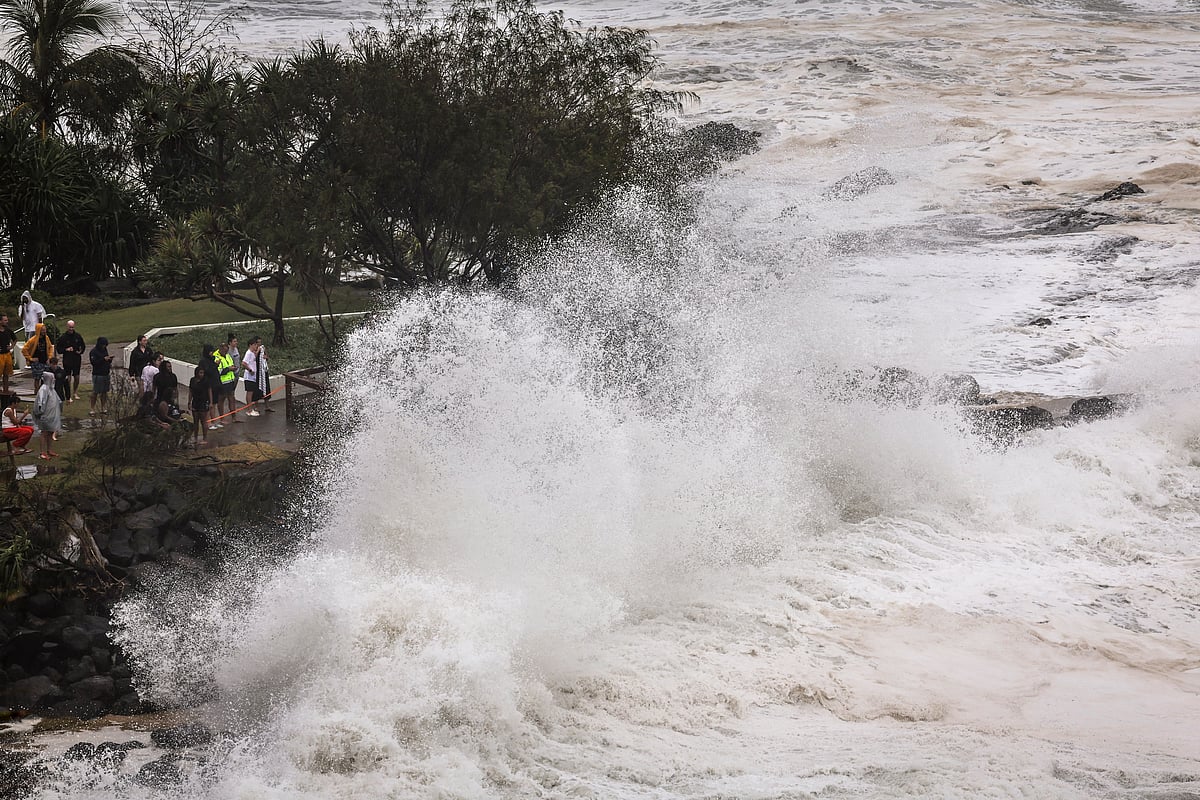 People watch record-breaking waves as the outer fringe of Tropical Cyclone Alfred started whipping eastern Australia, in Coolangatta on the Gold Coast.