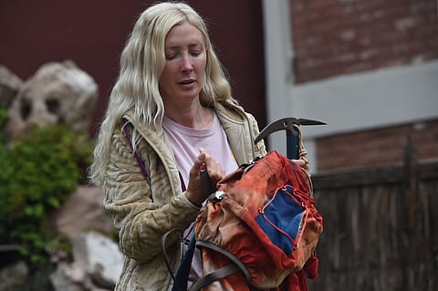 Azul Vieiro, 44, daughter of the late legendary mountaineer Guillermo Vieiro, poses for a picture with her father's rucksack and pickaxe in Mendoza, Argentina, on February 28, 2025. After four decades trapped in the ice of the Tupungato volcano, the backpack left behind by the legendary climber when he died on an expedition in 1985 was rescued by his daughters, in an emotional journey that turned the history of South American mountaineering on its head.