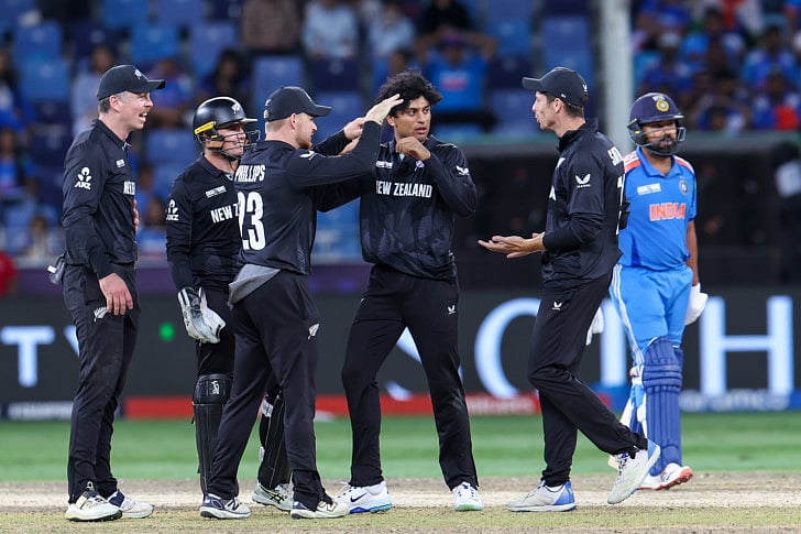 New Zealand's Rachin Ravindra celebrates the wicket of Rohit Sharma in the Champions Trophy final at Dubai International Stadium on Sunday.