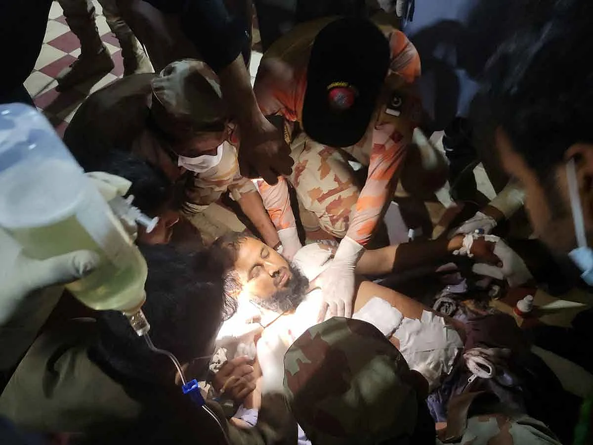 Paramedics treat an injured passenger at the Mach railway station, which has been turned into a makeshift hospital, after Pakistani security forces freed nearly 80 passengers following a security operation against armed militants who ambushed the train in the remote mountainous area, in Mach, southwestern Balochistan province on March 11, 2025. 