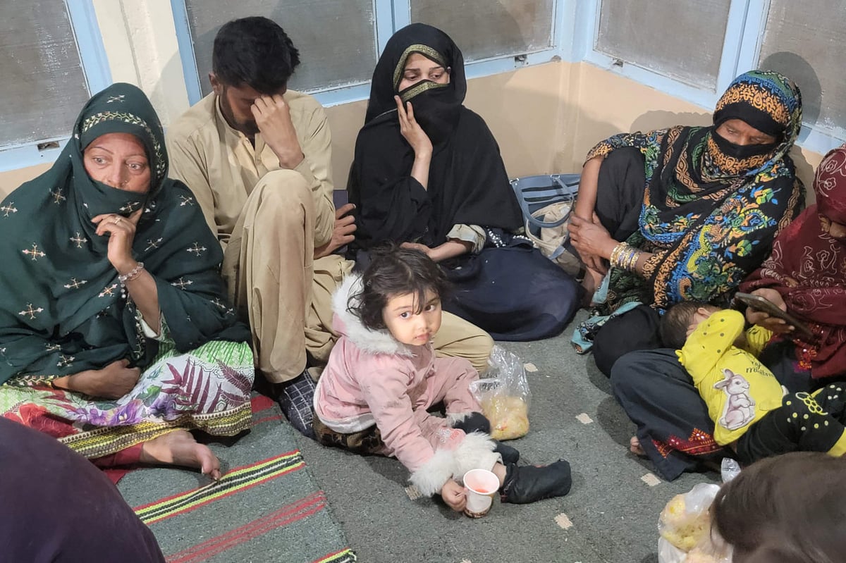 Passengers gather at the Mach railway station after Pakistani security forces freed nearly 80 passengers following a security operation against armed militants who ambushed the train in the remote mountainous area, in Mach, southwestern Balochistan province on March 11, 2025.