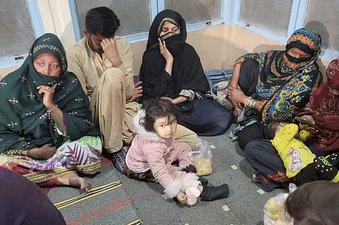 Passengers gather at the Mach railway station after Pakistani security forces freed nearly 80 passengers following a security operation against armed militants who ambushed the train in the remote mountainous area, in Mach, southwestern Balochistan province on March 11, 2025.  