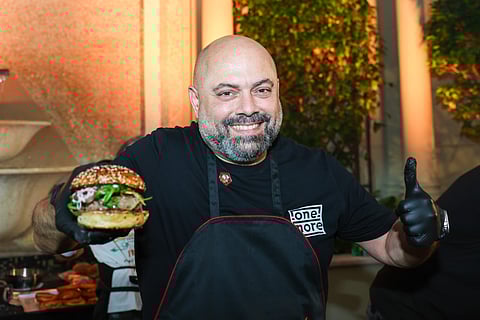 Hassan Naja showing "One More" burger which was crowned the World’s Best Burger in the US